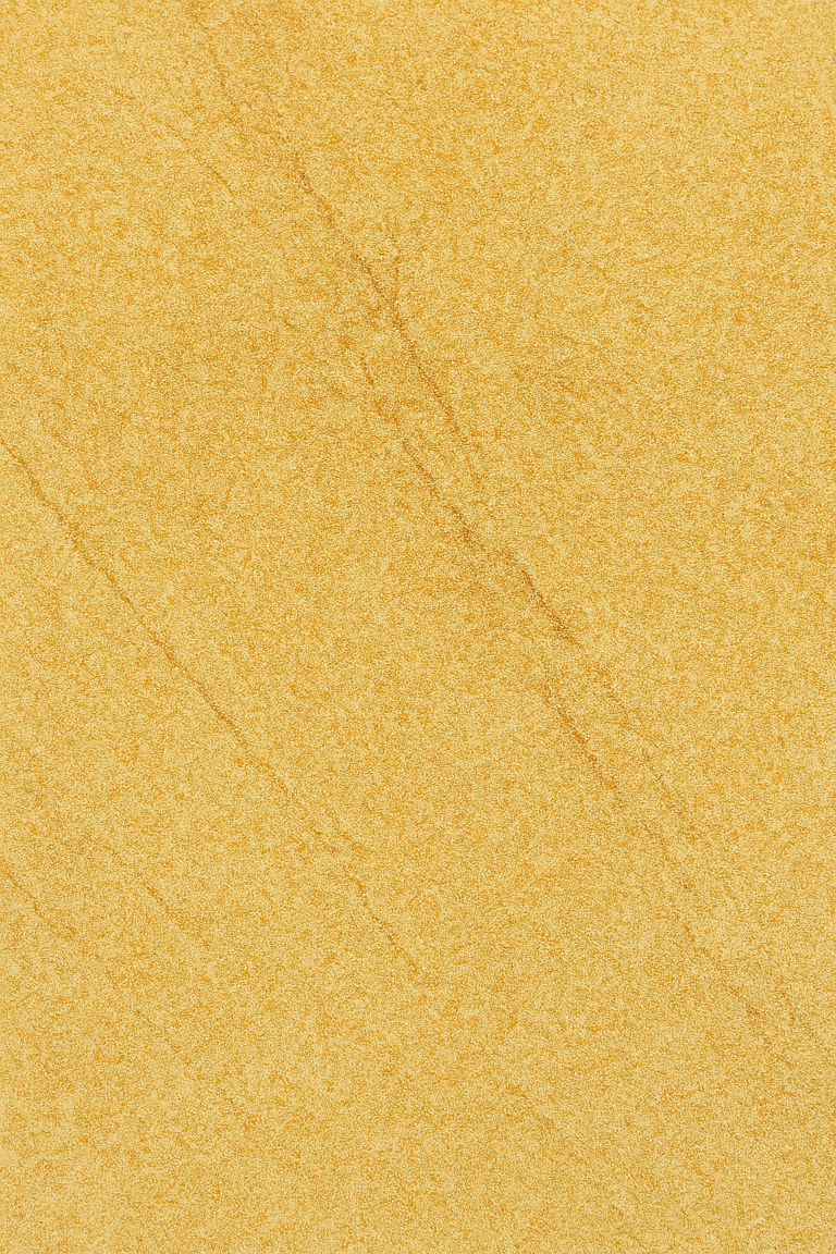 Close-up view of natural Jaisalmer stone with golden-yellow color and textured surface.